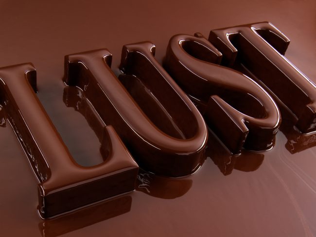 the letters lust turn up out of an ocean of melted chocolate