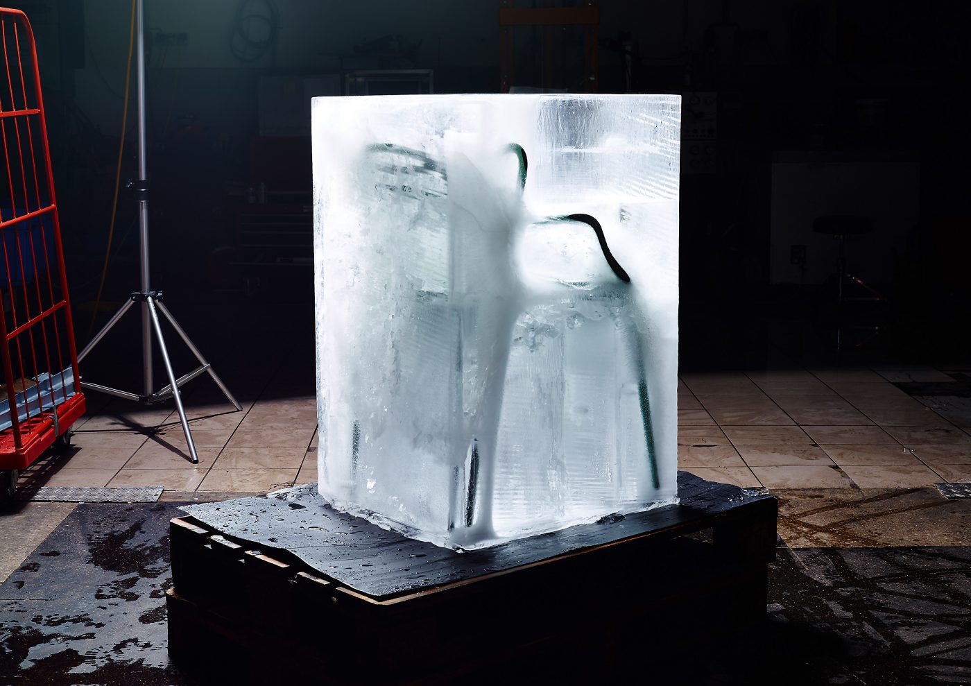 chait frozen into icecube in industrial hall dark background