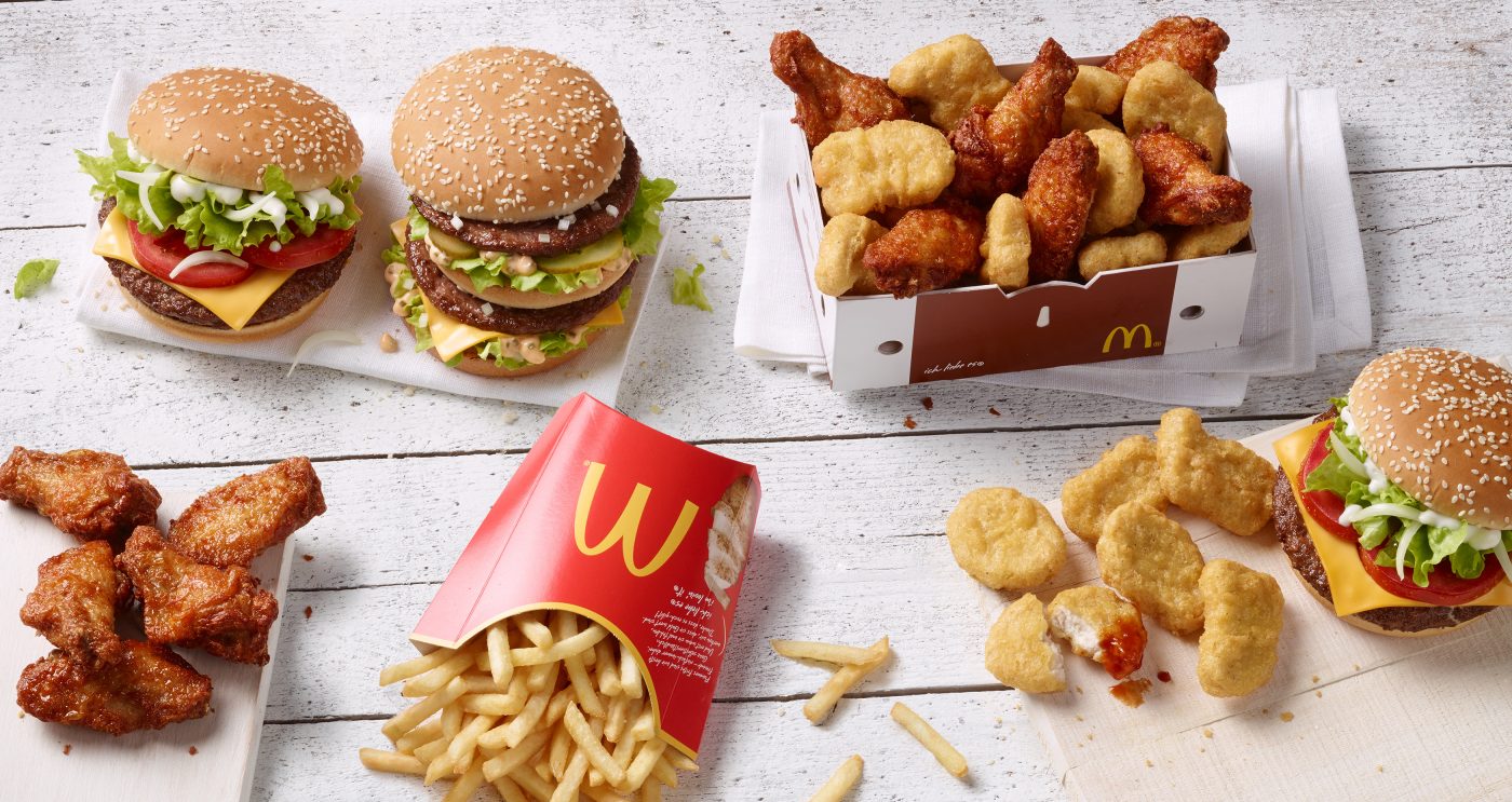 Local Store Marketing Foodphotography Shot of Big Tasty Bacon Bigmac French Fries Chicken Box with Chicken Wings and Nuggets on a white painted Underground