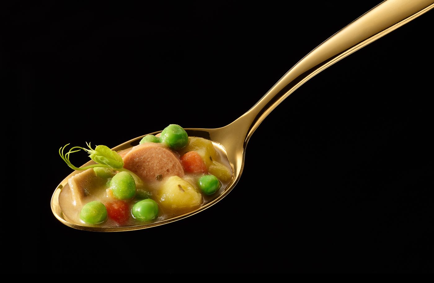 Vegan soup on golden spoon