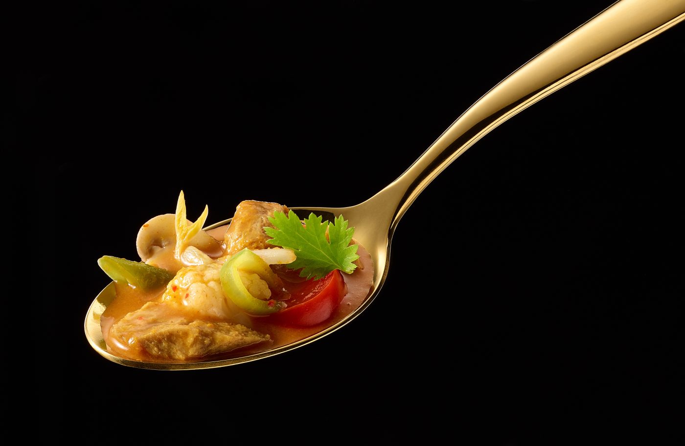 Vegan Thai Soup on a golden spoon