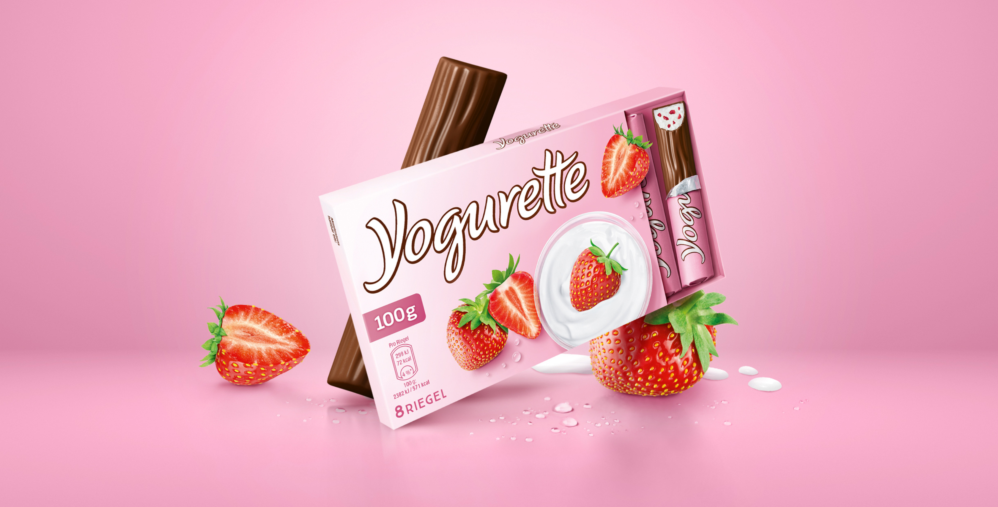 Packaging relaunch Yogurette, a package stands in a virtual pink room with strawberries, chocolate bars and milk drops