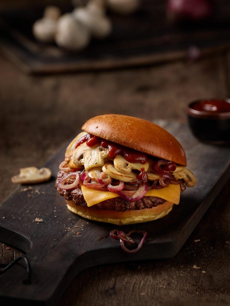freshly prepared Mushroom BBQ Burger in a setting of wood