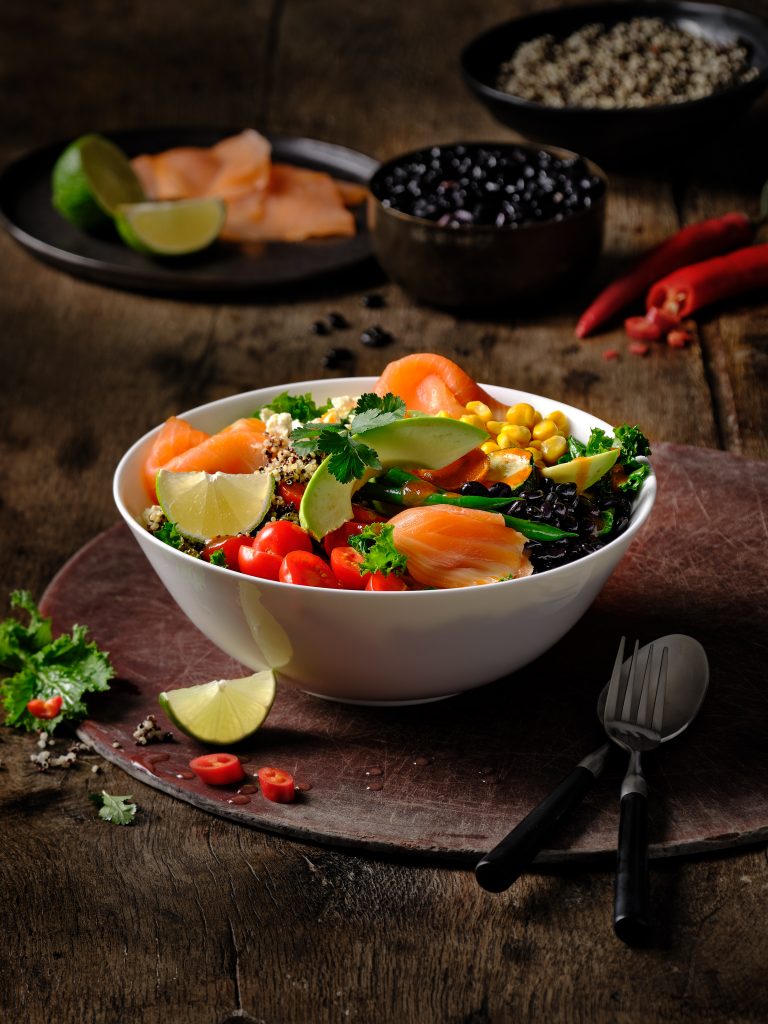 freshly prepared thai salmon bowl in a nich seting, wooden underground