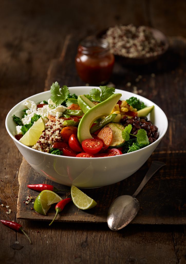 freshly prepared spicy avocado lime bowl is in a wood set